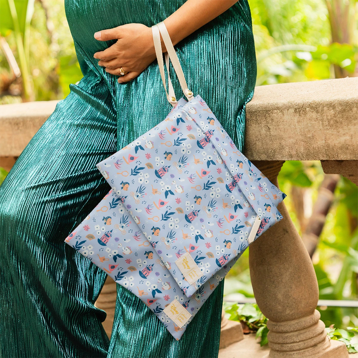 mom holding the wet bag duo in disney princess courage and kindness