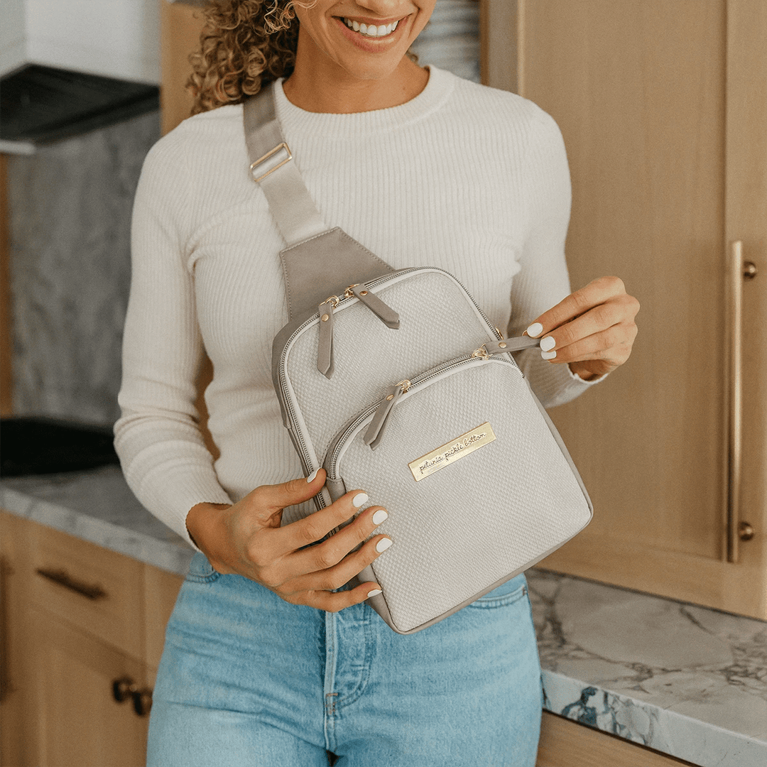 mom wearing the Criss-Cross Sling in Grey Matte Cable Stitch