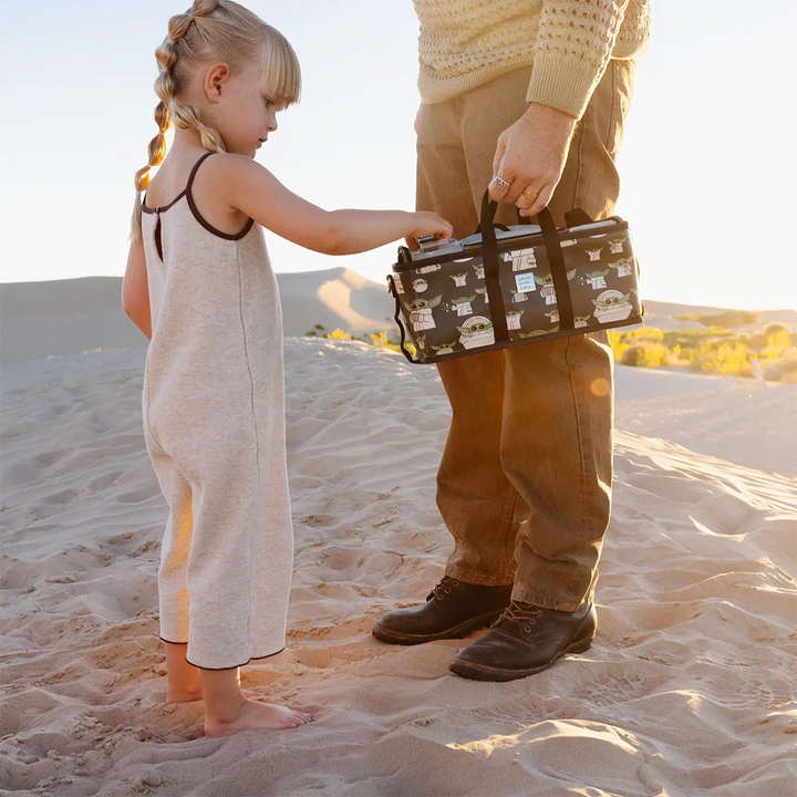 dad holding inter-mix deluxe kit in the child while baby girl takes out a pixel