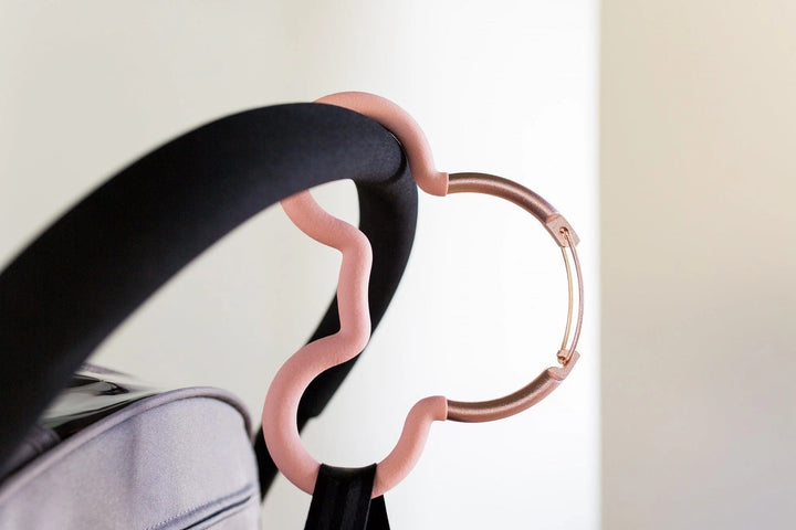 mickey mouse stroller hook in rose gold attached to stroller