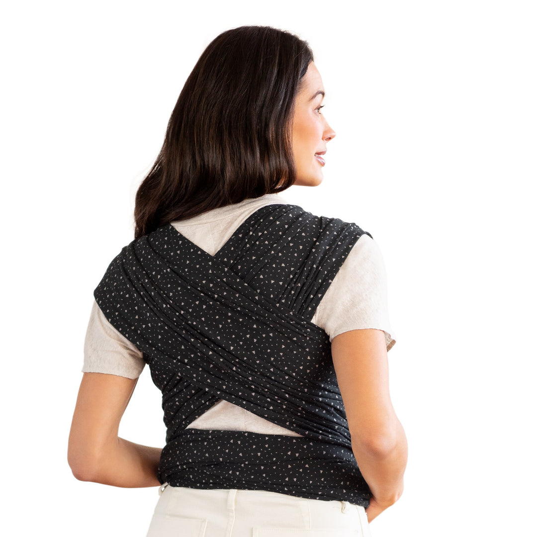 back image of mom wearing baby in petunia x moby classic wrap in terrazzo