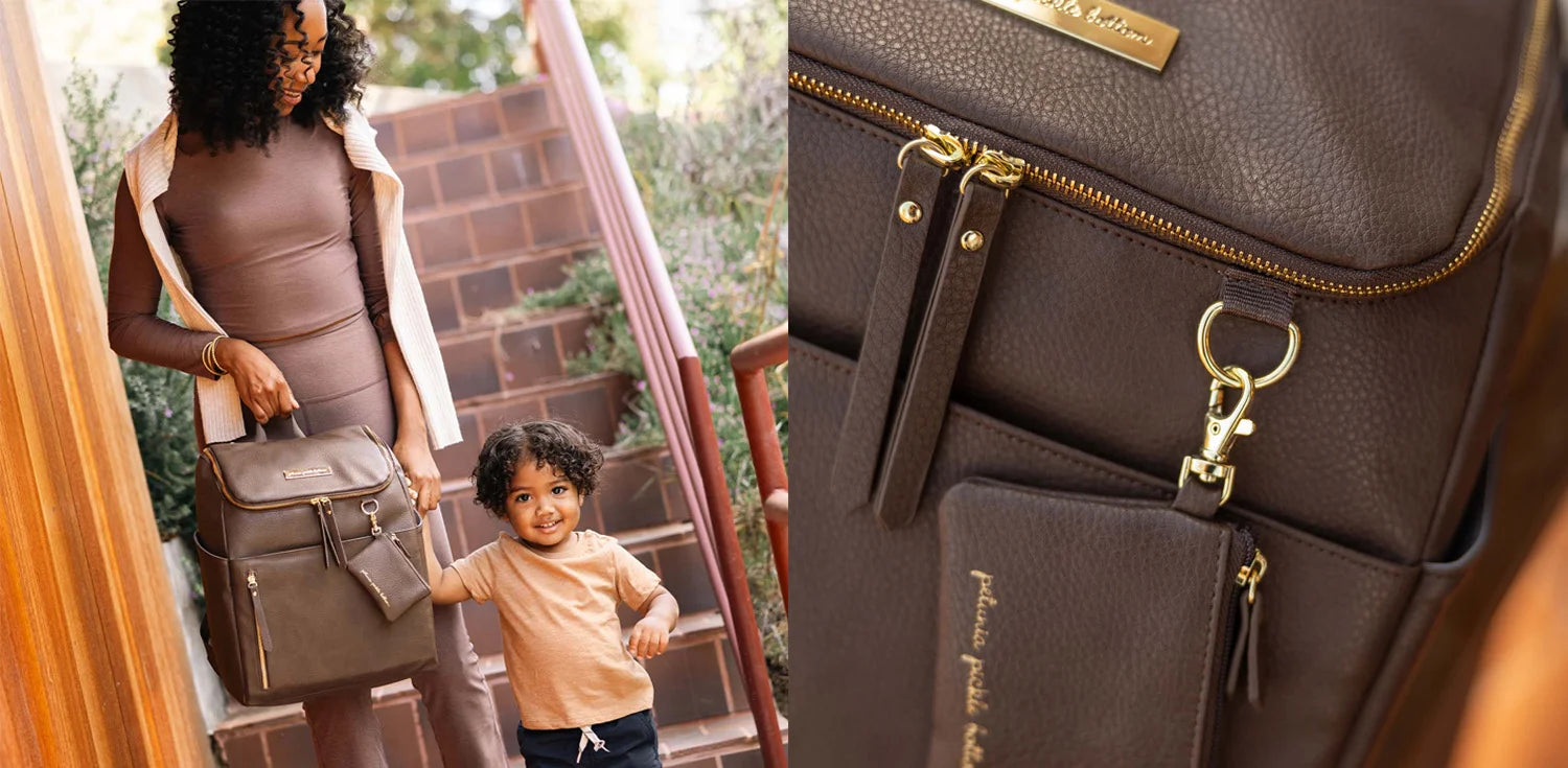 mom holding kid's hand while walking down the stairs and also holding the tempo backpack in saddle